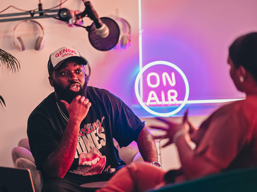 Man and woman chatting together in podcast studio