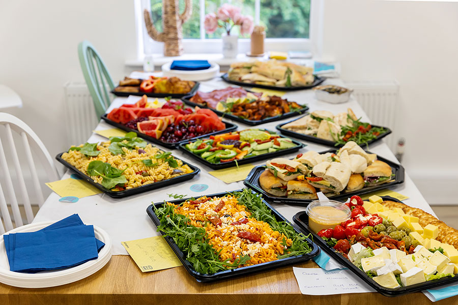Party food platters on wooden table.