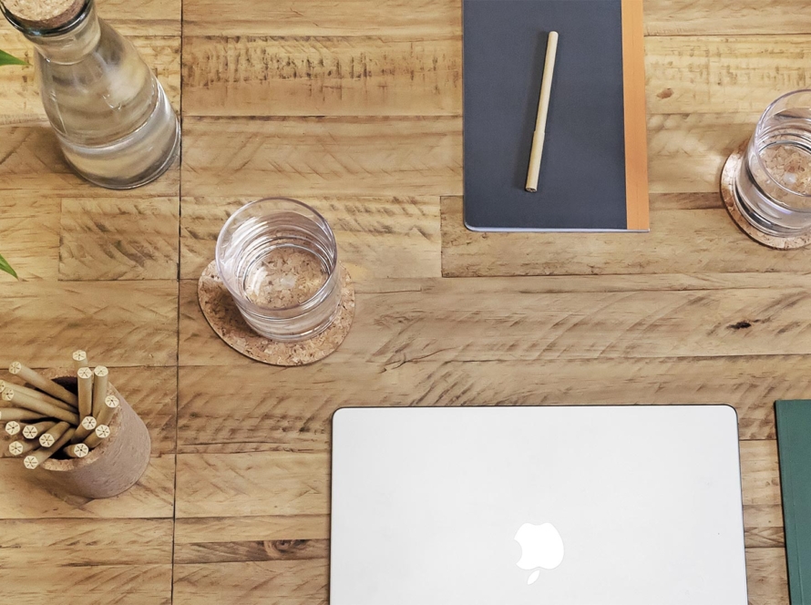 Laptop, phone, to do list pad on white desk