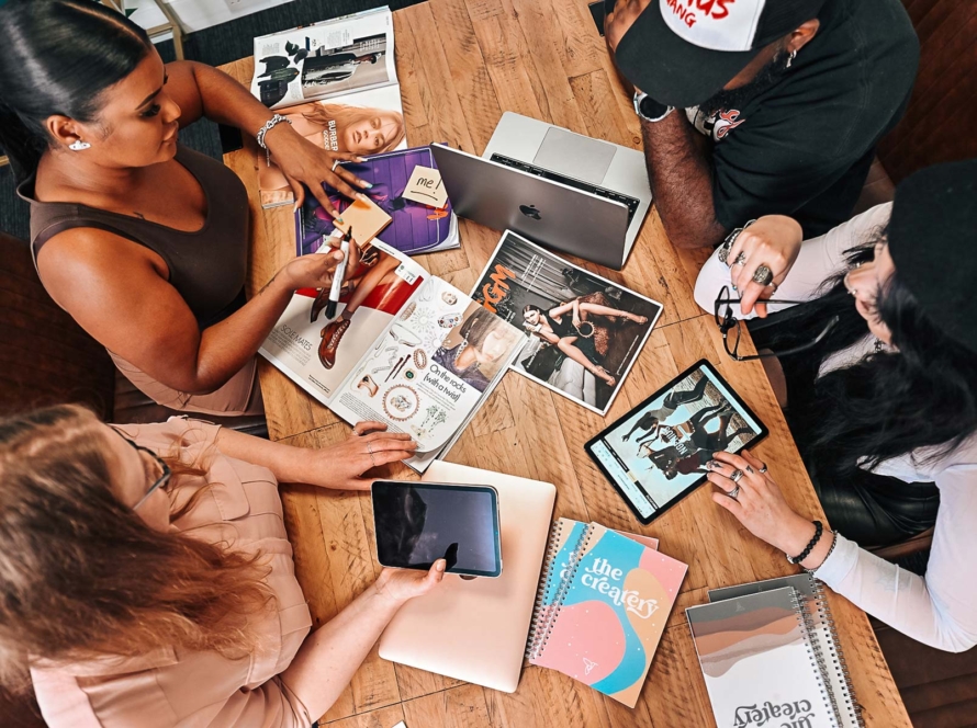 Top down view of people sitting round a desk at a Createry event